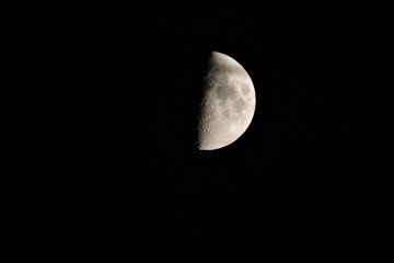 A view of the crescent moon with visible craters
