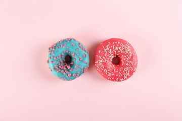 Top view composition of lush donut with colorful sprinkled icing, on bright paper textured...