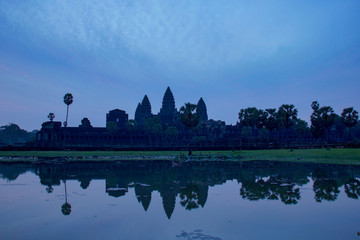 Fototapeta na wymiar Angkor Wat temple reflected in the water at sunrise