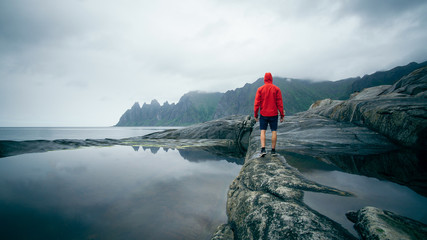  Man traveling on the stone Traveling in Norway Lifestyle adventure vacations outdoor. Norwegian...