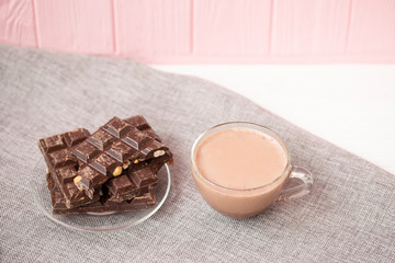 Hazelnut and almond milk and dark chocolate pieces tower. Chocolate bars on table with chocolate tower. Chocolate and nuts and choco swirl.