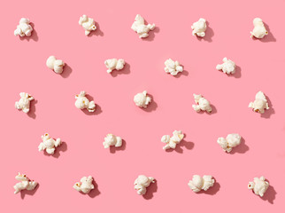 Popcorn on pink background. Texture.