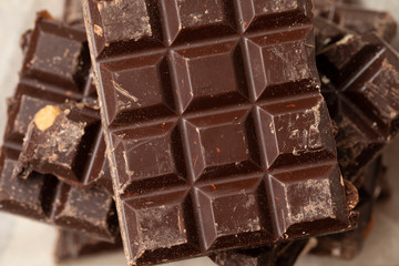 Noble dark chocolate on a wooden table in vintage style 