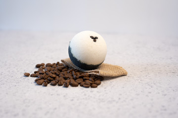 Bath bombs with coffee grains on a white background