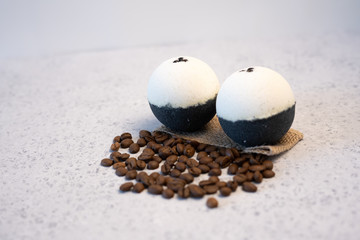 Bath bombs with coffee grains on a white background
