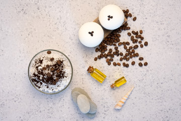 Aromatherapy and spa concept. Spa salt with coffee scent near soap, spa oil and loofah on white background top view