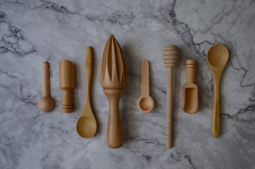 Wooden kitchen utensils on marble table in the kitchen. Top view