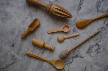 Wooden kitchen utensils on marble table in the kitchen. Top view