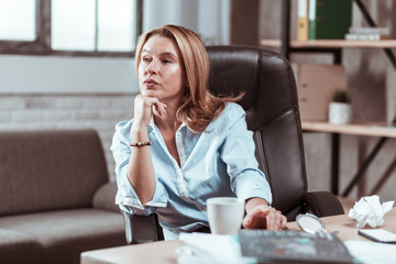 Businesswoman feeling concerned thinking about new business plan