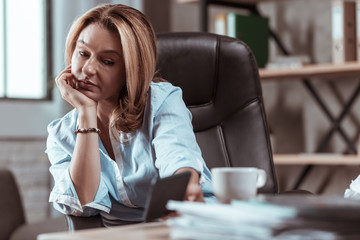 Businesswoman wearing stylish bracelet holding new smartphone