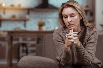 Mature woman feeling depressed thinking about husband cheating