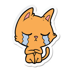 sticker of a crying cartoon cat sitting