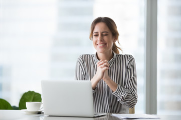 Excited businesswoman wishing for business success or celebrating victory