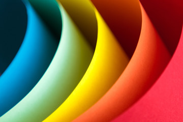 Close up of multicolored origami pattern made of curved sheets of paper.