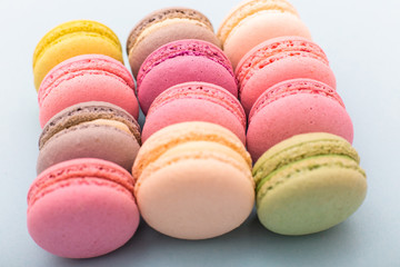 Cake macaron or macaroon on turquoise background from above, almond cookies, pastel colors