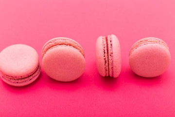 Top view of tasty pink macaroons isolated on pink background