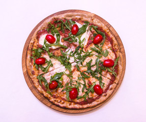 Flat lay pizza with arugula and cherry tomatoes on white background