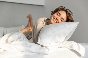 Foto op Aluminium Smiling young girl relaxing in bed © Drobot Dean