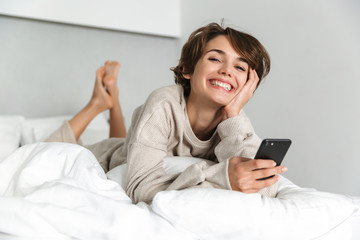Smiling young girl relaxing in bed