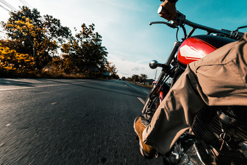Man rides motorcycle on an empty asphalt road