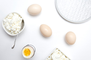 Top view of boiled eggs and curd cheese prepared for tasty and dieting lunch. Food as a source of vitamins