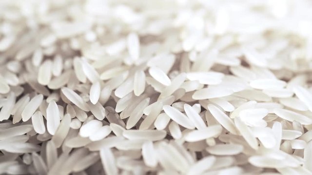 4K footage of rotating extreme close-up uncooked white rice.