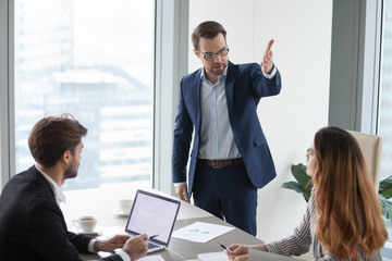 Rude angry boss demanding to leave meeting irritated by businesswoman