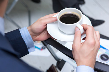 Man hands and cup of coffee. Coffee break concept
