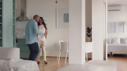 happy young couple dancing at home enjoying funny dance having fun celebrating