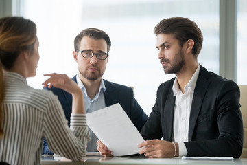 Skeptical male hr managers unconvinced about hiring female candidate