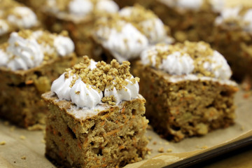 Cakes with carrots, walnuts and meringue. Fresh pastries in the bakery, vegetarian sweets