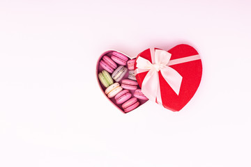 macaroons cookies on a heart box with red ribbon bow isolation on a white background