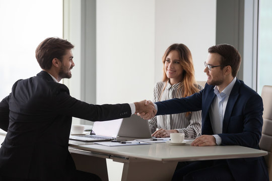 Business partners shaking hands negotiating at office meeting, collaboration concept