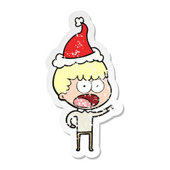 distressed sticker cartoon of a shocked man wearing santa hat