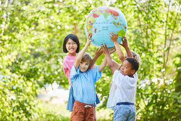 Children group as a team holds a globe