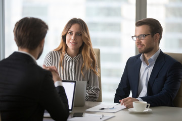 Executing colleagues listening to partner making business offer at meeting