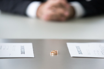 Close up view of decree paper and rings on table