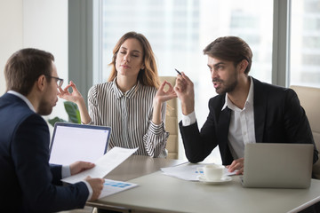 Calm healthy businesswoman meditating at stressful office meeting concept