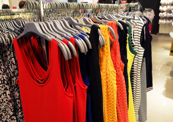 colorful clothes hanging on the hanger in the showroom