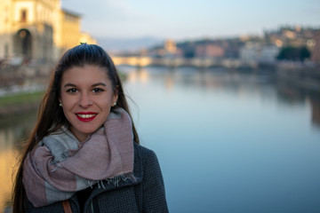 florence,tuscany/Italy 22 february 2019 :portrait of a woman in front of ponte vechio she smile and...