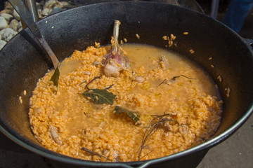 Rice in a cauldron with garlic. Pilaf. Cooking