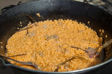Rice in a cauldron with garlic. Pilaf. Cooking