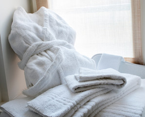 white bathroom clothing set with a bathrobe, wipes and slippers