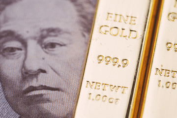 Bullion, gold or ingot on Japanese yen banknote using as wealth, investment and safe haven on financial crisis