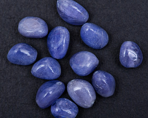 Soft blue violet TANZANITE extra quality beads from Tanzania isolated on black background.