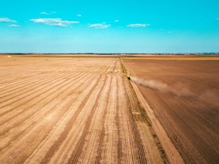 Obraz premium Aerial view of agricultural tractor on dirt road