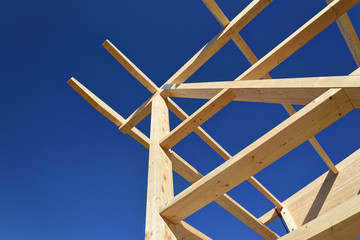 construction frame made of wood against blue sky