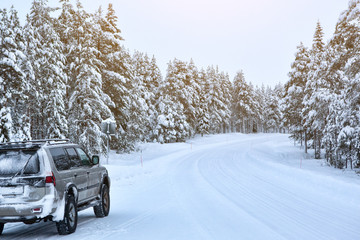 Suv car stay on roadside of winter road. Family trip to ski resort. Winter holidays adventure. car on winter road