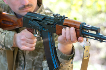 automatic machine gun in the hands of the military