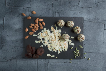 raw vegan sweets without sugar with ingredients on board. lifestyle with top view 